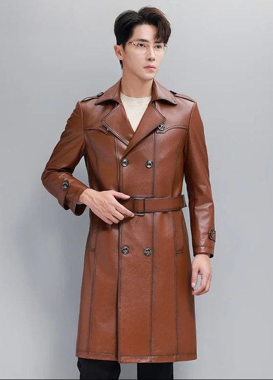 Men’s cowhide leather trench coat in Nutmeg, model holding the belt — From Borcelleclothes.