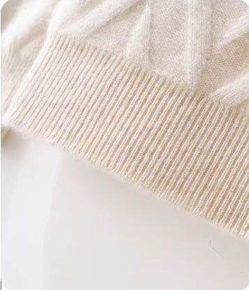 The ribbed bottom hem on the Men's Dimensional Abstract Sprouts Wool Sweater in Almond, providing structure and a tailored look. From Borcelleclothes.
