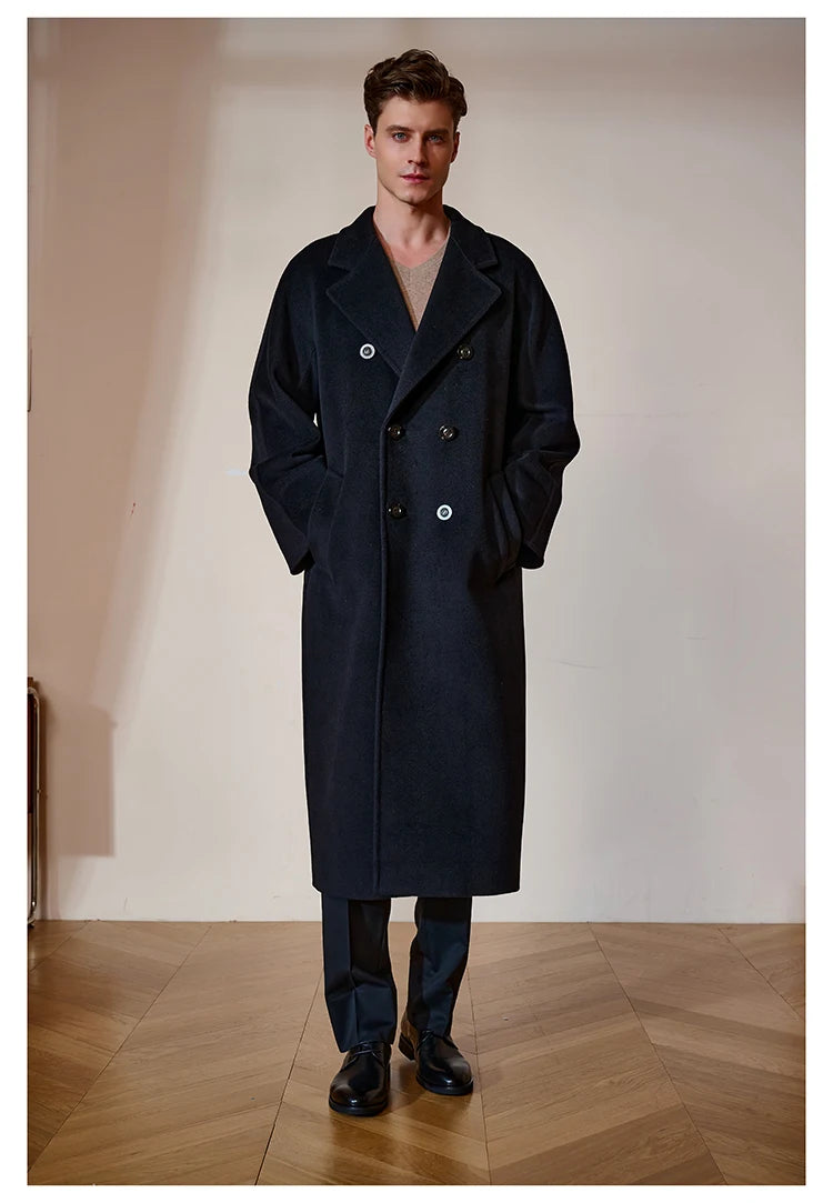 Model wearing the Men’s Double-Breasted Belted Cashmere Coat in Black Pearl, with hands in pockets, showcasing its relaxed elegance and clean design. From Borcelleclothes.