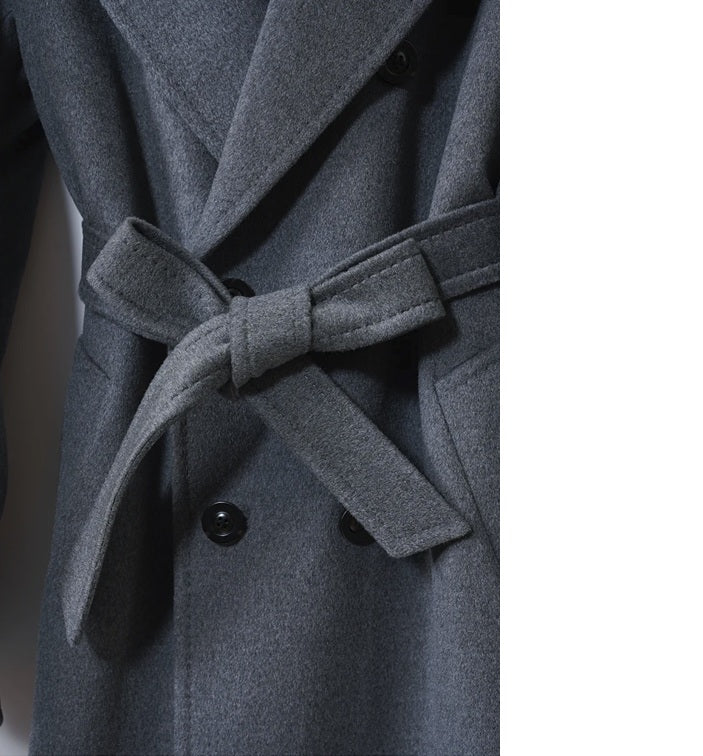 The waist of the Men’s Double-Breasted Belted Cashmere Coat in Bright Grey, with the belt tied in a bow for a structured yet effortless fit. From Borcelleclothes.