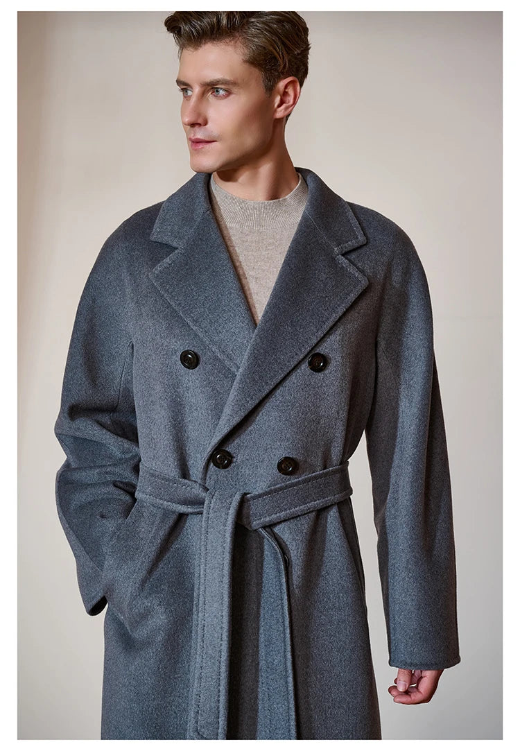 Model wearing the Men’s Double-Breasted Belted Cashmere Coat in Bright Grey, gazing to the side. Showcasing its structured yet fluid silhouette and refined lapels. From Borcelleclothes.
