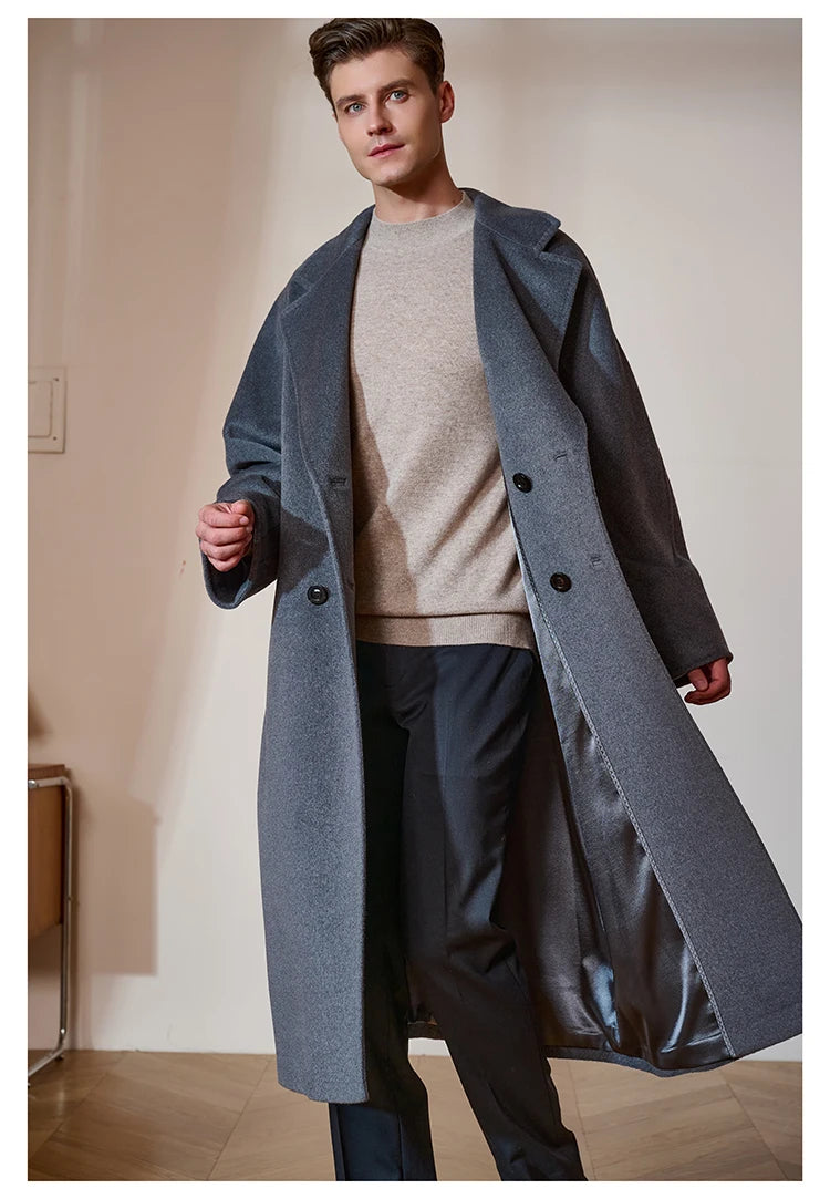Model in the Men’s Double-Breasted Belted Cashmere Coat in Bright Grey, moving to reveal the smooth interior lining and fluid drape. From Borcelleclothes.