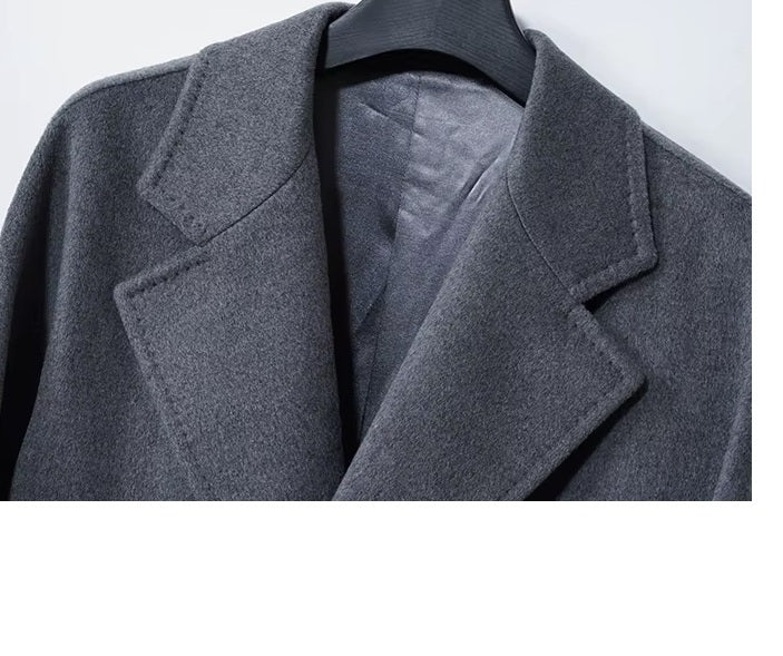 The upper part of the Men’s Double-Breasted Belted Cashmere Coat in Bright Grey, featuring notch lapels and refined craftsmanship. From Borcelleclothes.