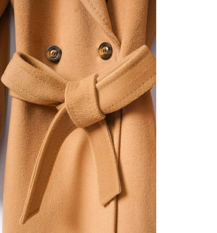 The waist of the Men’s Double-Breasted Belted Cashmere Coat in Whiskey, with the belt tied in a neat bow for a polished finish. From Borcelleclothes.