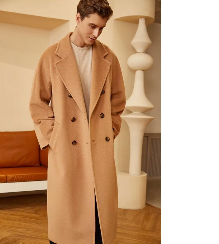 Model wearing the Men’s Double-Breasted Belted Cashmere Coat in Whiskey, head slightly bent, capturing the coat’s relaxed yet refined appeal. From Borcelleclothes.