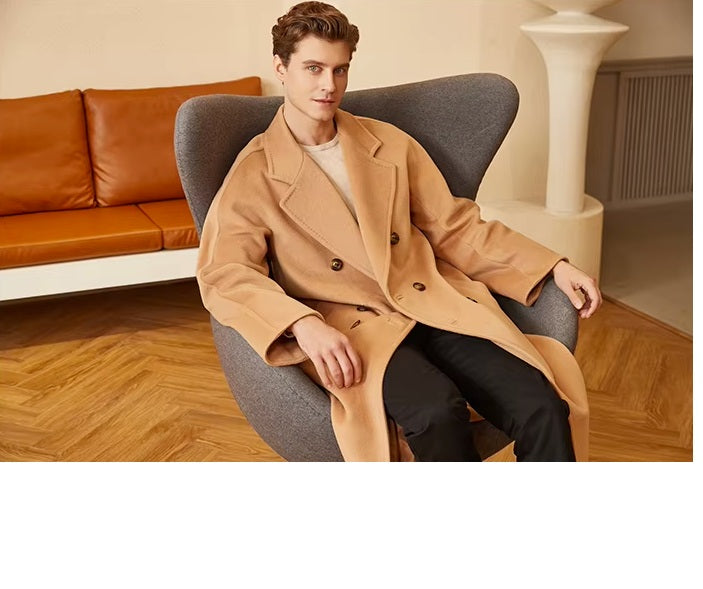 Model in the Men’s Double-Breasted Belted Cashmere Coat in Whiskey, seated in an armchair, reflecting the coat’s effortless sophistication. From Borcelleclothes.
