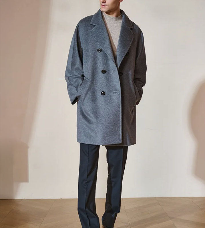 Men’s Double-Breasted Cashmere Coat in Light Slate Grey, crafted from a luxurious blend of cashmere and high-count wool. Featuring a fluid silhouette, integrated sleeve construction, and a refined six-button front closure. From Borcelleclothes.