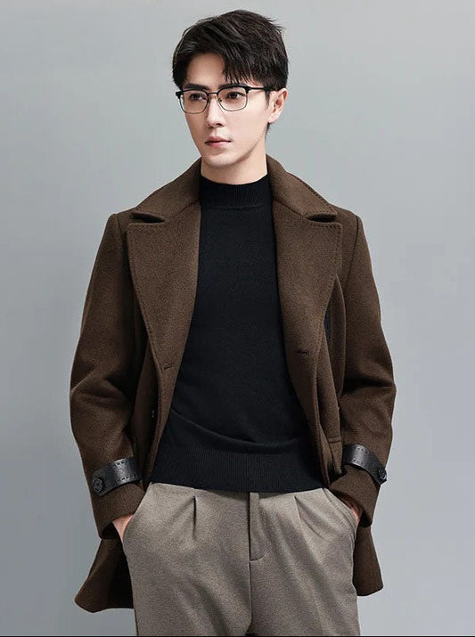 Model wearing Dark Rum double-breasted wool-cashmere coat with hands in pants pockets. From Borcelleclothes.
