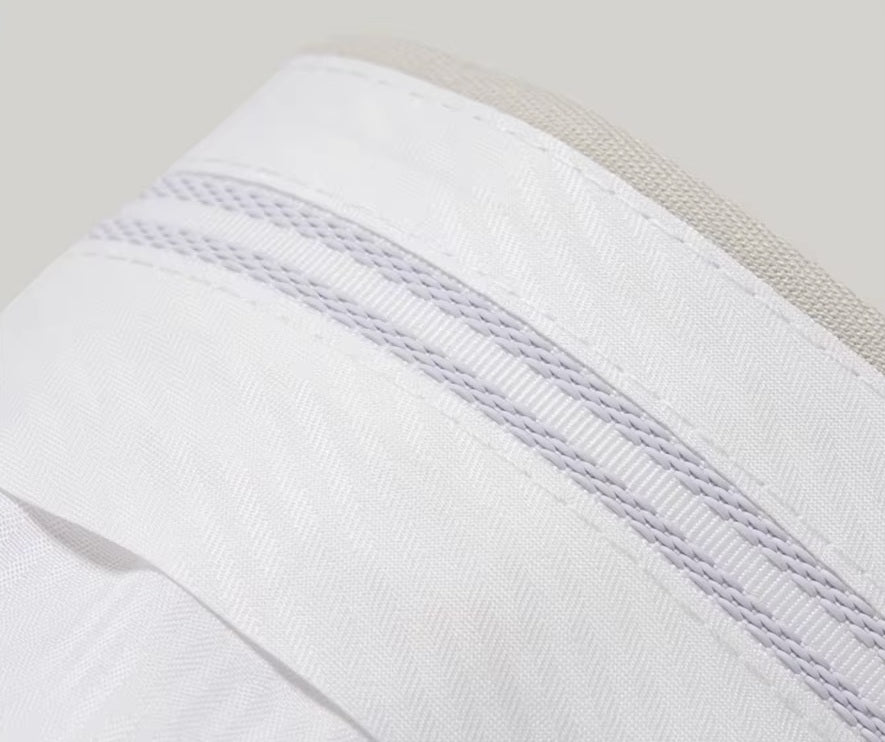 The gripper tape inside the waistband of the pants from the Borcelleclothes Men's Ecru White Suit, designed to keep shirts securely tucked.