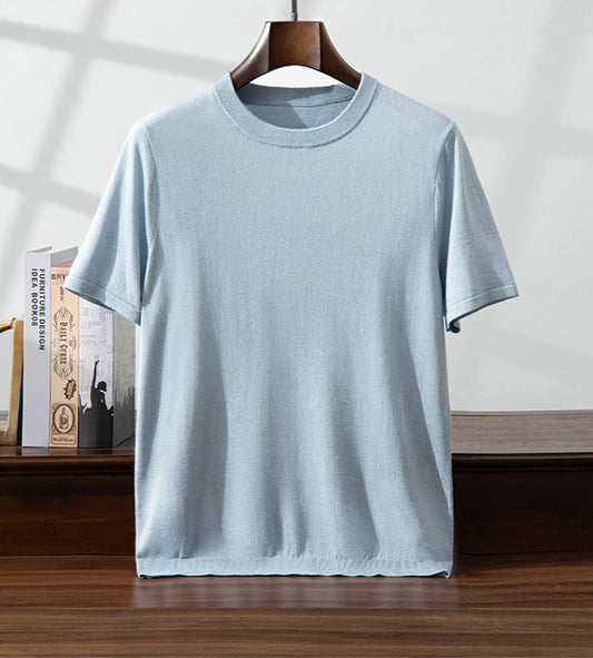 Men’s fine-knit silk-cashmere T-shirt in Jungle Mist, gently draped on a hanger to highlight the softness and light texture of the natural fibers. From Borcelleclothes.