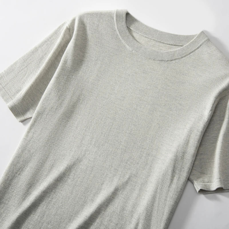 Upper part of the Men’s fine-knit silk-cashmere T-shirt in Silver Sand — lightweight and breathable knit with a smooth surface, ribbed neckband, and bottom hem. From Borcelleclothes.