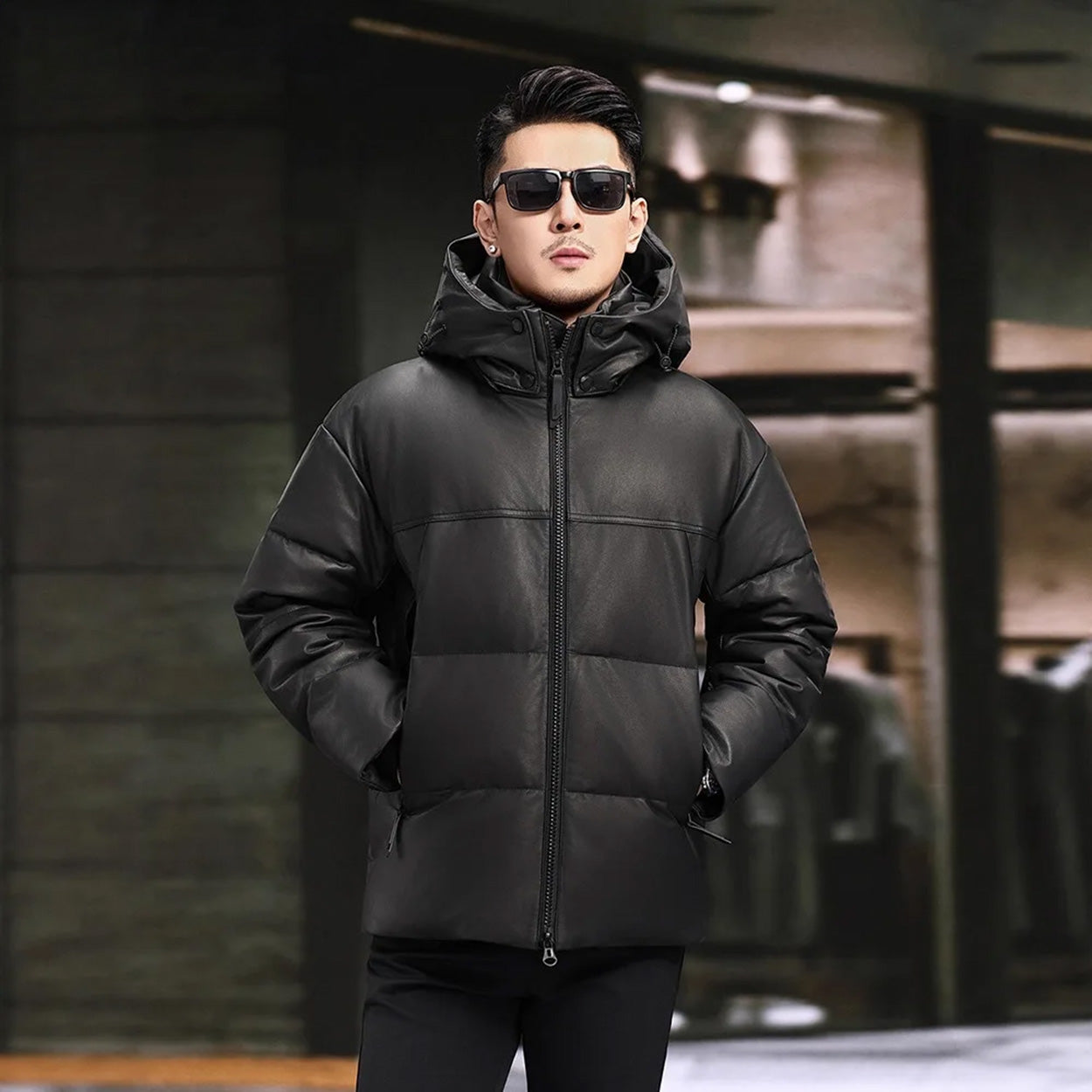 Men’s down jacket with hands in vertical zip pockets, showing smooth leather and minimal seams — From Borcelleclothes.