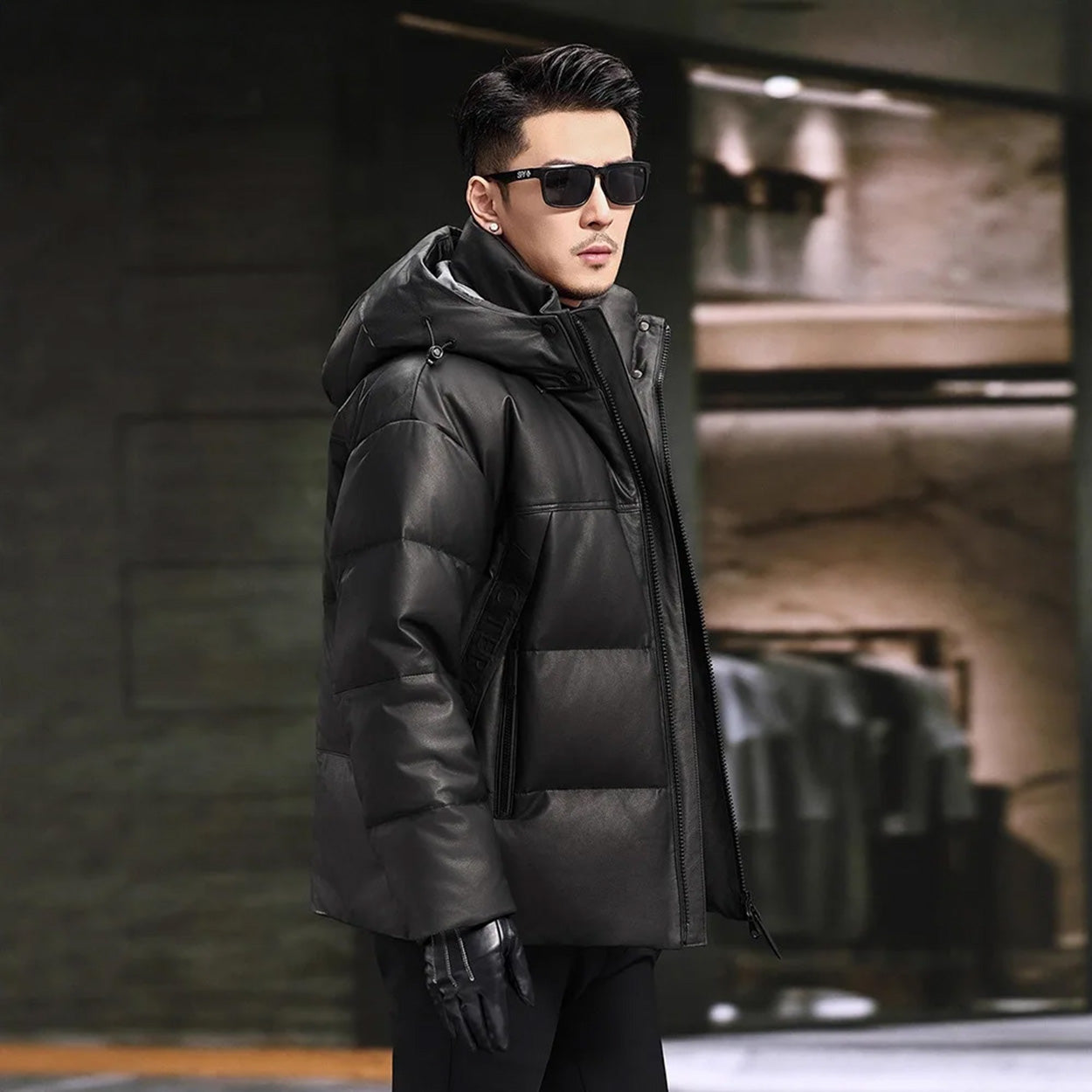 Side view of men’s cowhide jacket with sculptural hood and dropped shoulders in Abyss color — From Borcelleclothes.