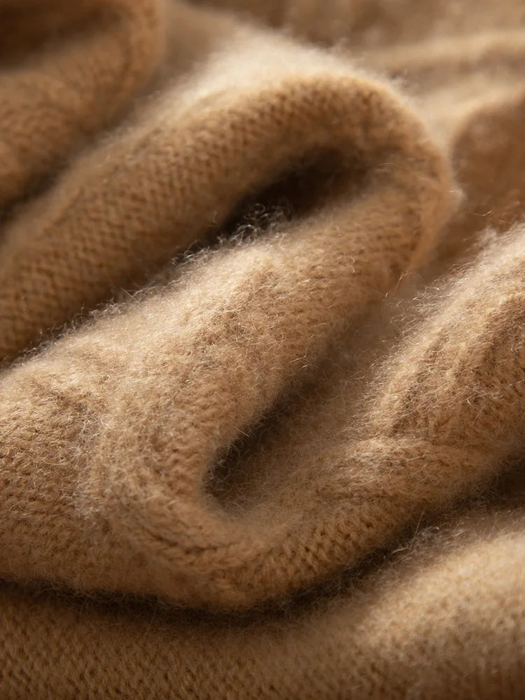 Lion-colored hybrid neck cashmere sweater folded to display the soft wave-like structure and cable-knit pattern — From Borcelleclothes.