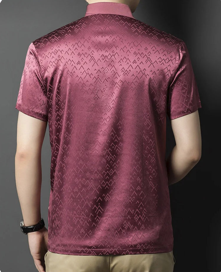 Back view of the Coral Tree polo on a man, where the fabric’s sheen and pattern convey presence without display. From Borcelleclothes.