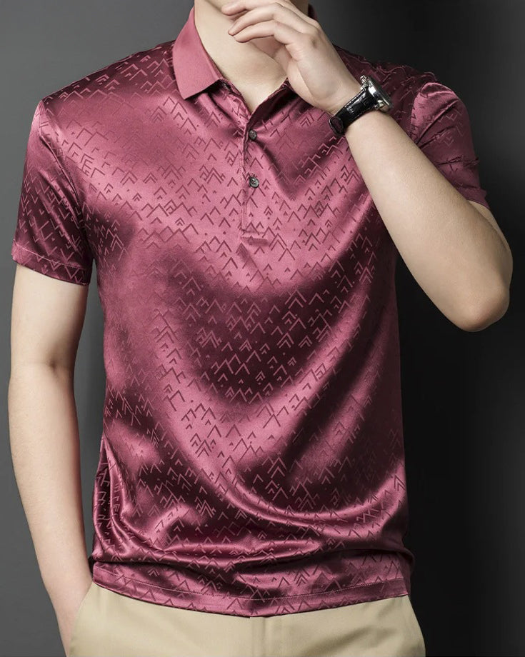 Front view of the Coral Tree silk polo worn by a man — warm, composed, and inscribed with geometric calm beneath the surface. From Borcelleclothes.