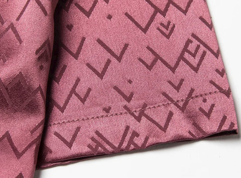 Sleeve detail of the Coral Tree polo with subtle volume and visible jacquard directionality over the warm silk tone. From Borcelleclothes.