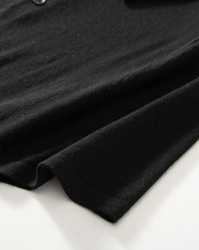 Ribbed hem of the Men’s knitted silk-cashmere polo shirt in Onyx — featuring a soft drape and wide collar that rests gently on the shoulders. From Borcelleclothes.