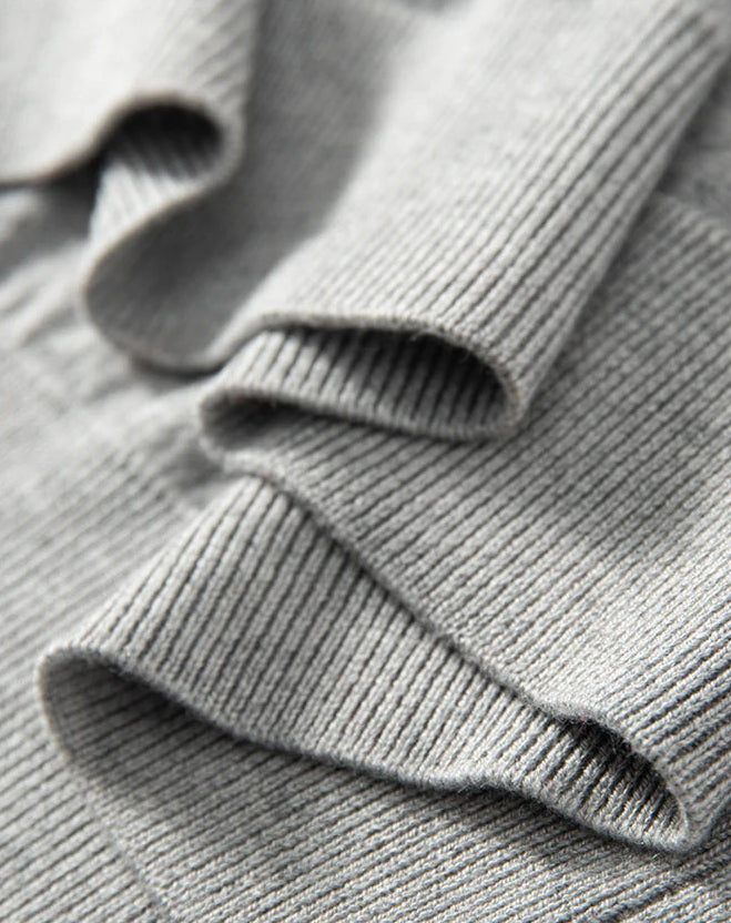 Ribbed hem of the Men’s knitted silk-cashmere polo shirt in Silver Sand — featuring a soft drape and wide collar that rests gently on the shoulders. From Borcelleclothes.