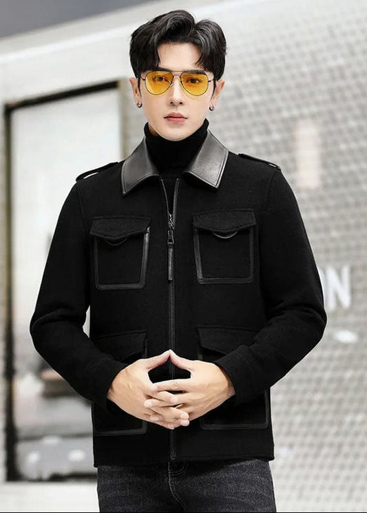 Onyx men’s leather-accented mini-coat, model with crossed fingers, highlighting structured mini-coat silhouette and leather accents. From Borcelleclothes.