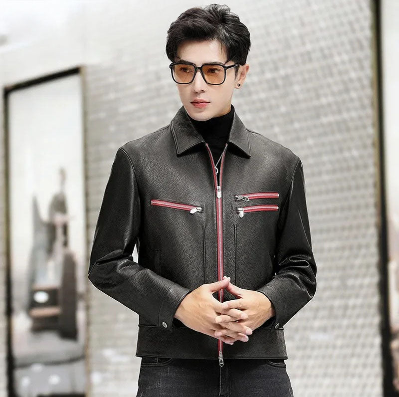 Model standing in a black goatskin leather jacket with Carmine Pink zipper accents, hands lightly crossed at the waist — From Borcelleclothes.