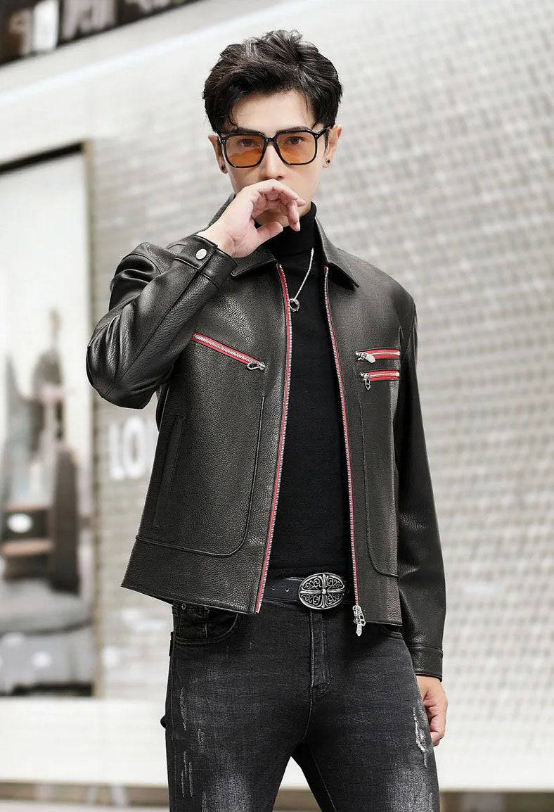 Model in a black goatskin jacket with Carmine Pink zippers, touching lips gently with one hand — From Borcelleclothes.