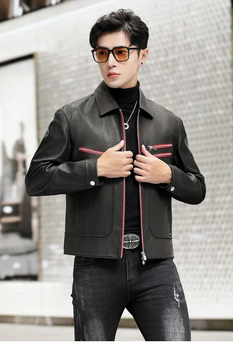 Model wearing an unzipped black leather jacket with Carmine Pink trim, holding both front sides near the hem — From Borcelleclothes.