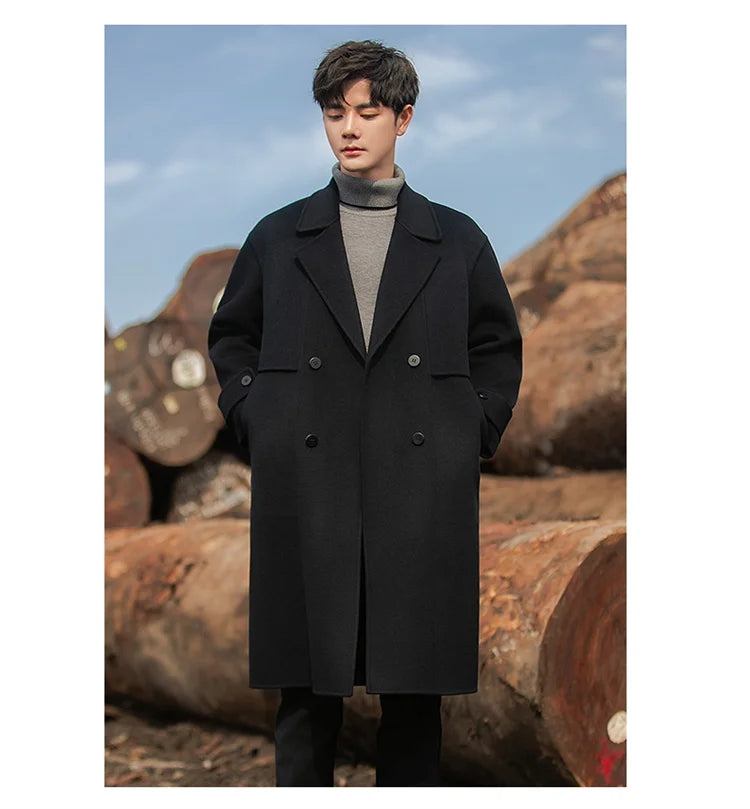 A model wearing the Men's Luxurious Double-Faced Coat in Onyx, with hands in pockets, highlighting the seamless integration of the slash pockets into the coat’s structured composition. From Borcelleclothes.