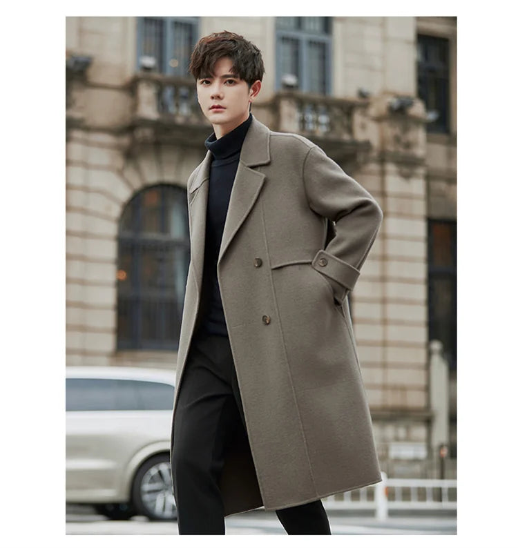 A model wearing the Men's Luxurious Double-Faced Coat in Sandstone, highlighting the slash pocket subtly integrated into the structured design. From Borcelleclothes.