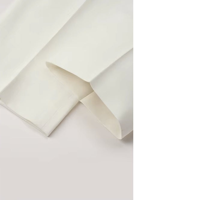 The Men's Luxury Alabaster Suit's pants bottom, showcasing the hem detailing and premium tailoring. From Borcelleclothes.