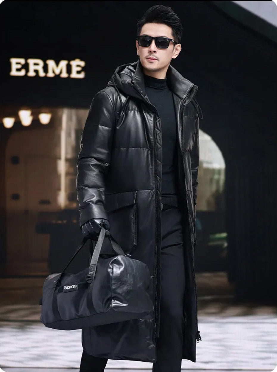 Model in mid-calf Onyx coat holding oversized black bag, silhouette anchored by the coat’s structure — From Borcelleclothes.