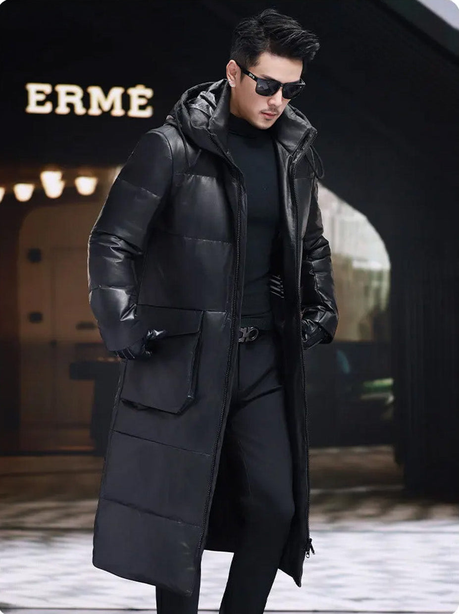 Model with head lowered, front unzipped; sculptural collar-hood and inner reflective lining partially visible — From Borcelleclothes.