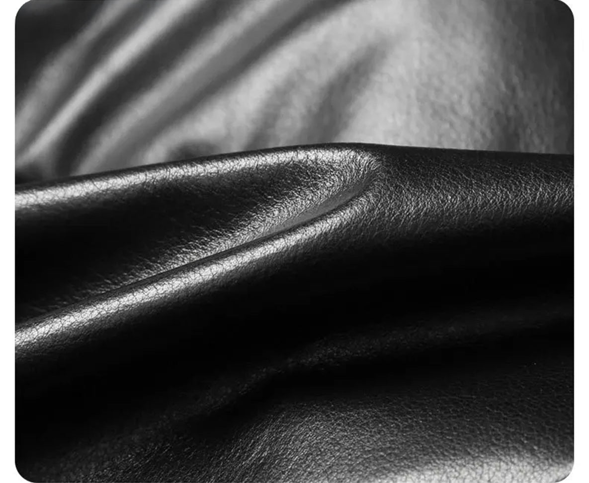 Textural fold in Onyx cowhide leather; light reveals sculpted wave-like surface — From Borcelleclothes.