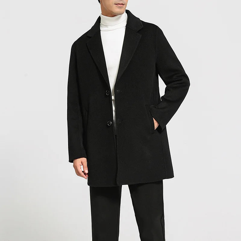Men’s mid-length double-faced wool coat in Onyx with notch lapels and two-button closure. From Borcelleclothes.