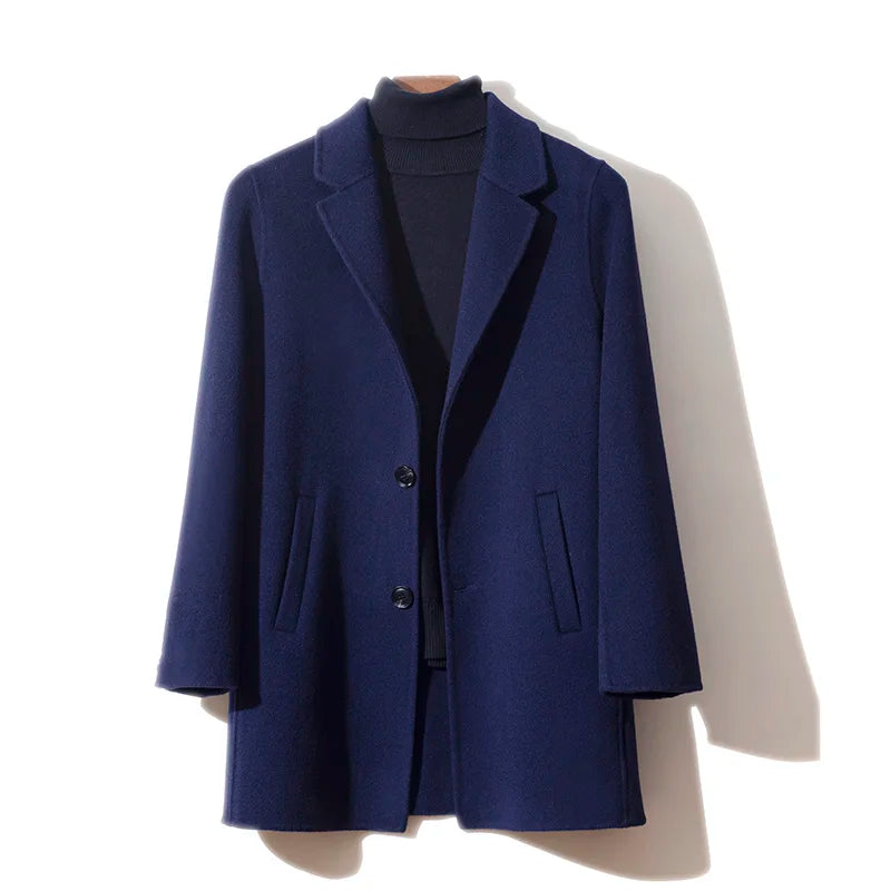 Men’s mid-length double-faced wool coat in Paua with two-button closure. From Borcelleclothes.