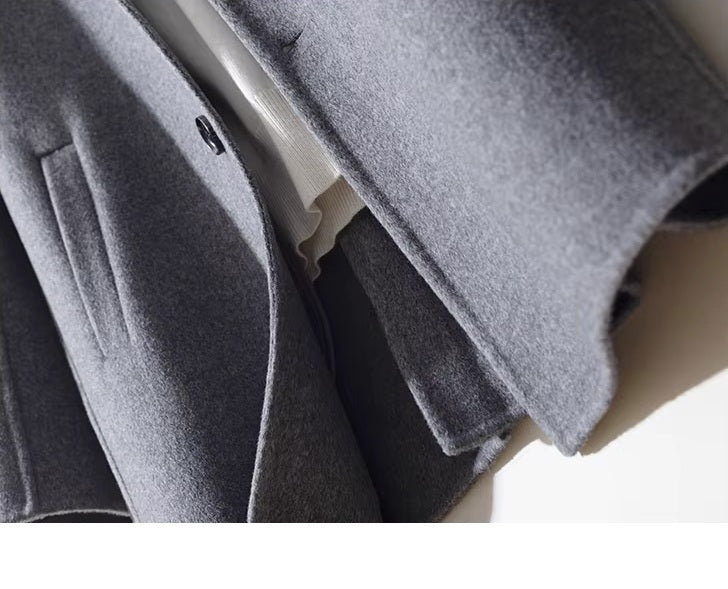 Bottom section of men’s mid-length wool coat in Topaz showing clean hemline. From Borcelleclothes.