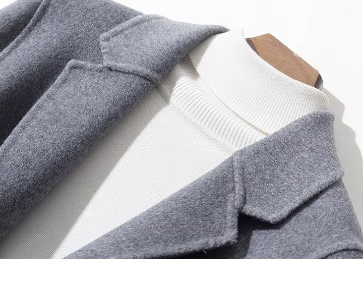 Collar detail of men’s mid-length wool coat in Topaz with notch lapels. From Borcelleclothes.