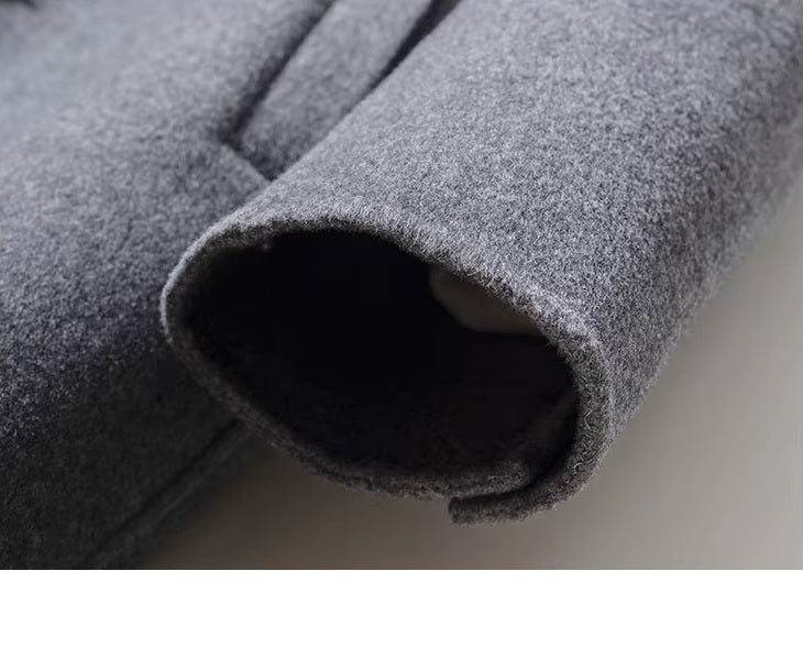 Sleeve cuff detail with decorative buttons on men’s mid-length wool coat in Topaz. From Borcelleclothes.