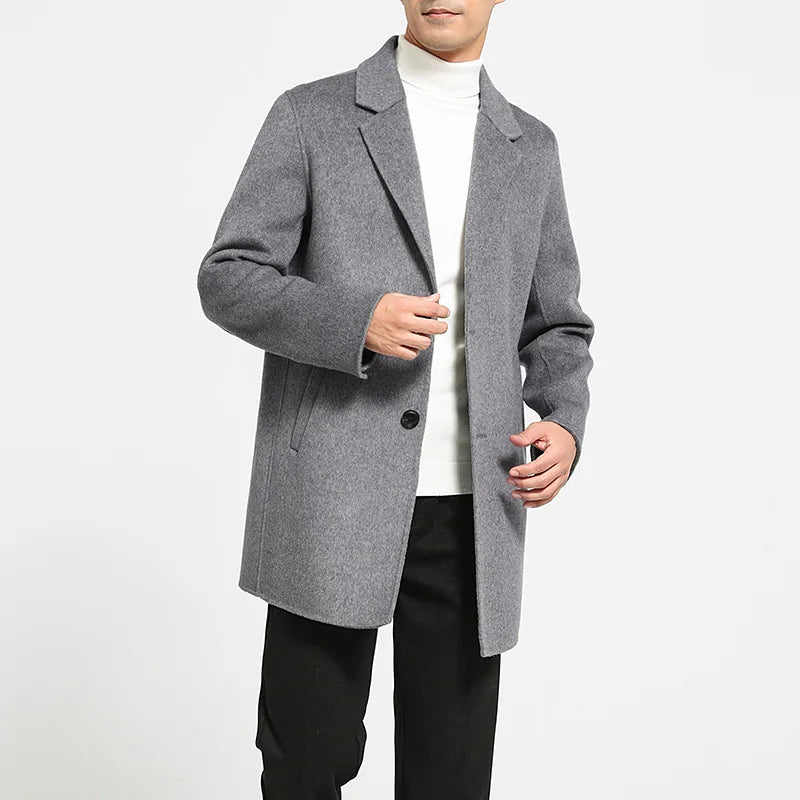 Men’s mid-length double-faced wool coat in Topaz with notch lapels and two-button closure. From Borcelleclothes.