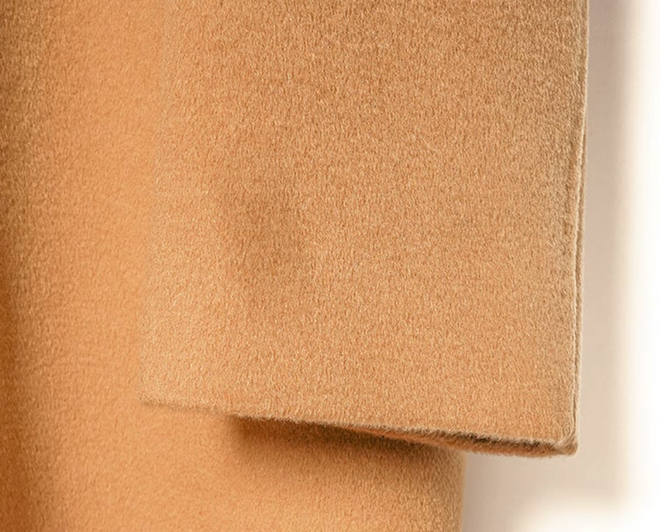 The sleeve end of the Men’s Minimalist Cashmere Coat in Burning Sand, showing the neatly finished cuff and fabric texture. From Borcelleclothes.