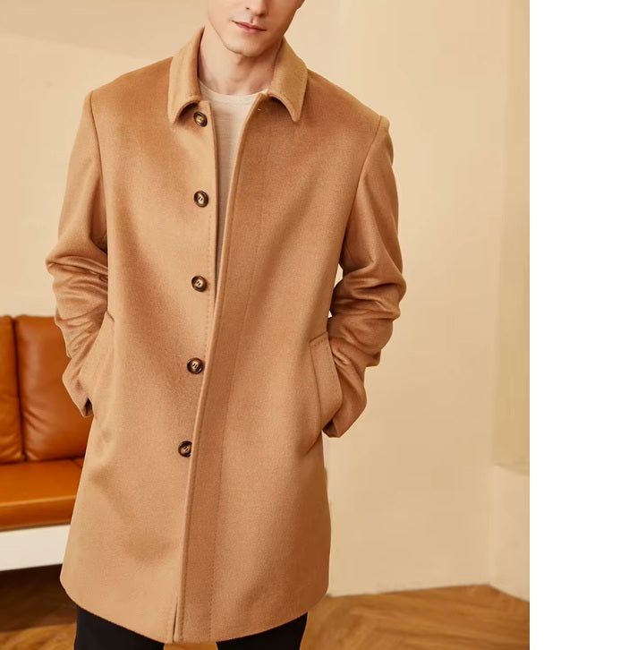 Men’s Minimalist Cashmere Coat in Burning Sand, with the model’s hands in the welt pockets, highlighting the sleek silhouette and minimalist design. From Borcelleclothes.
