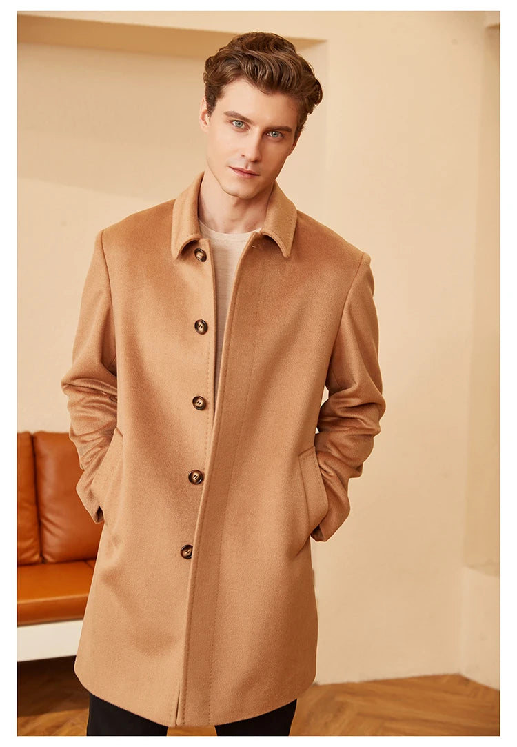 Model facing forward with hands in pockets, wearing the minimalist cashmere coat in Burning Sand. The clean silhouette and soft structure define the coat’s effortless elegance. From Borcelleclothes.