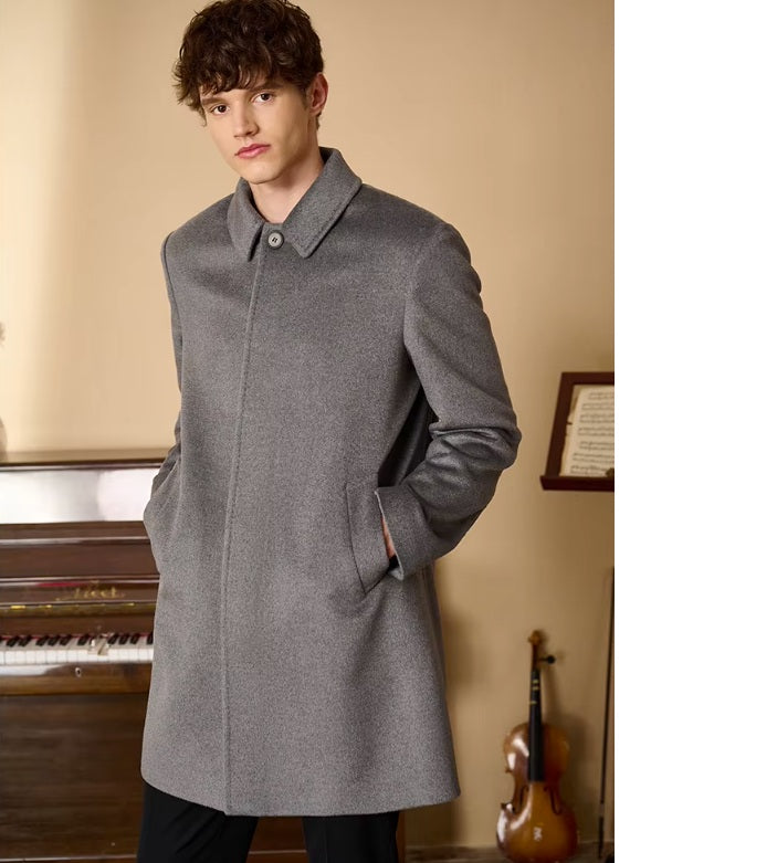 Model wearing the Men’s Minimalist Cashmere Coat in Hurricane, with hands in pockets, showcasing the coat’s structured silhouette and contemporary fit. From Borcelleclothes.