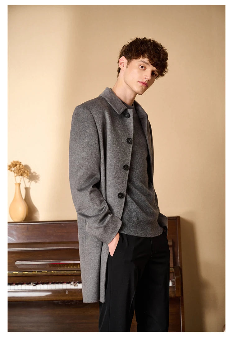 Men’s Minimalist Cashmere Coat in Hurricane, styled near a grand piano, reflecting the coat’s quiet sophistication and refined elegance. From Borcelleclothes.