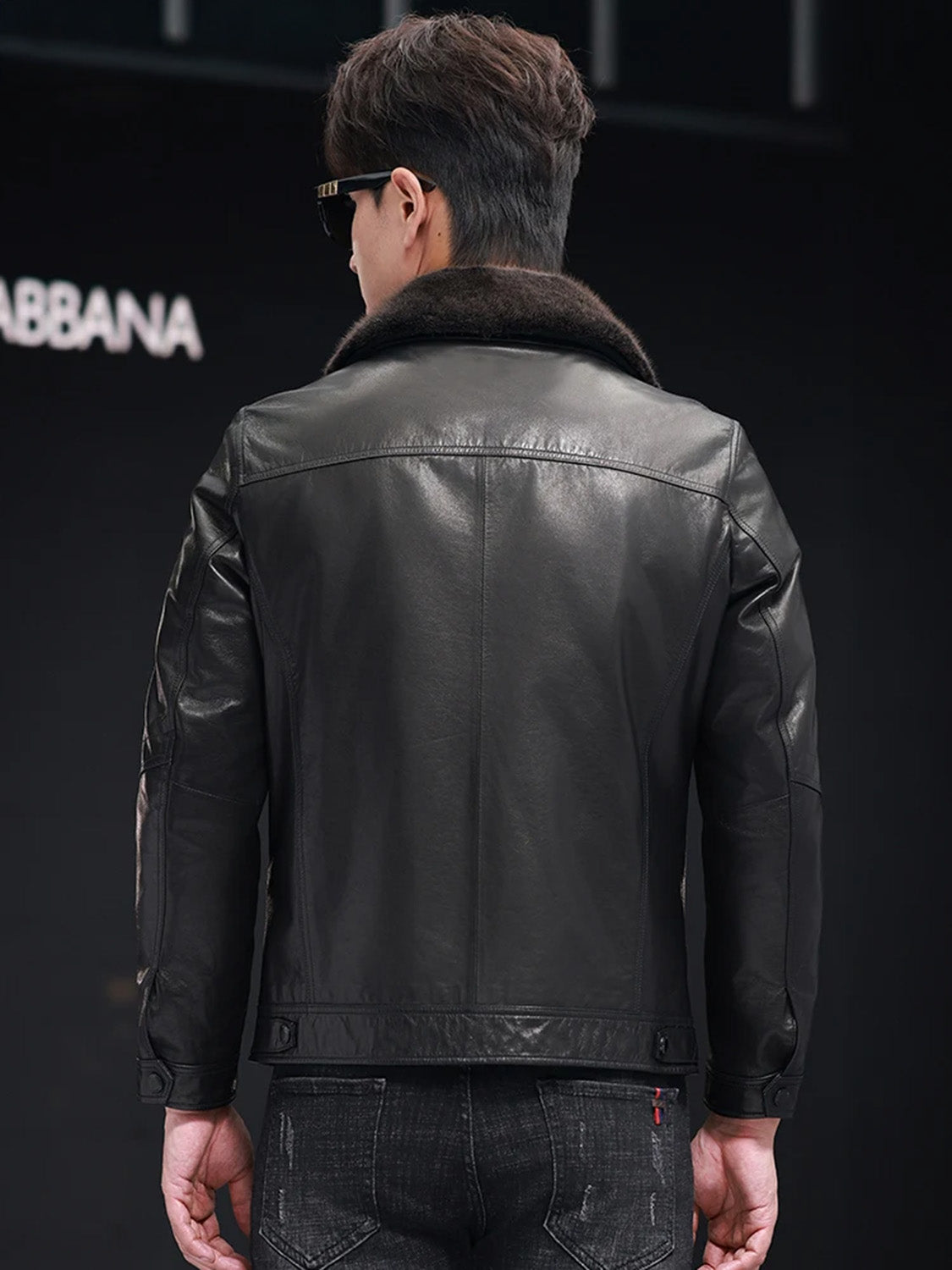 Back view of goatskin jacket with mink collar in Onyx worn by model — From Borcelleclothes.