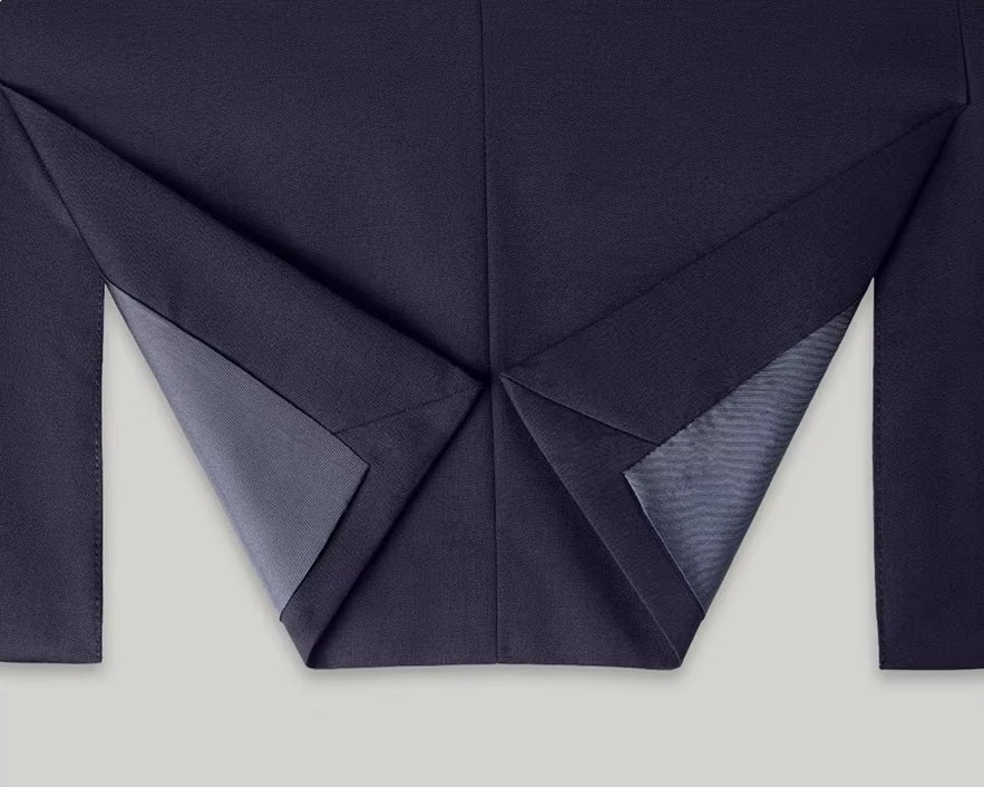 The folded back double vent of the blazer from the Borcelleclothes Men's Modern Gentleman’s Ebony Clay Suit, emphasizing mobility and tailoring.