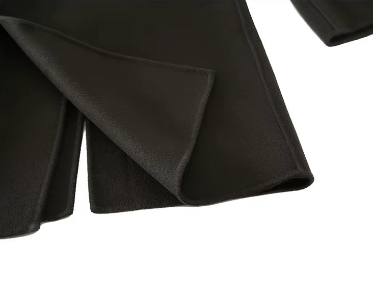 The back vent on the Men's Peaked-Lapel Wool Coat in Tuatara, designed for ease of movement and a refined drape. From Borcelleclothes.