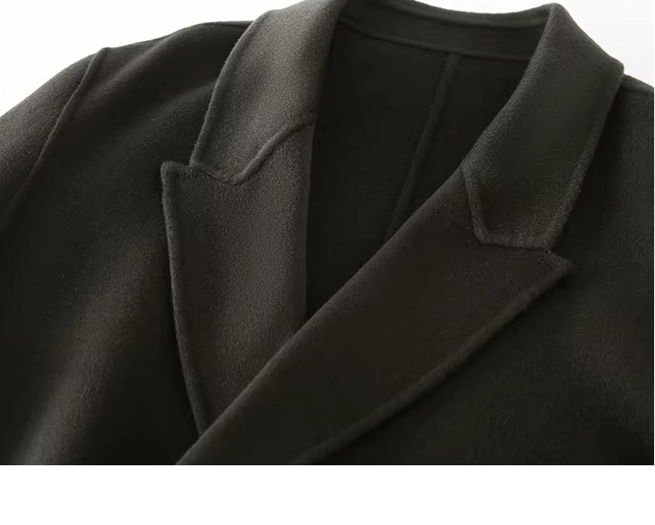 The peaked lapel collar on the Men's Peaked-Lapel Wool Coat in Tuatara, emphasizing sharp tailoring and clean finishing. From Borcelleclothes.