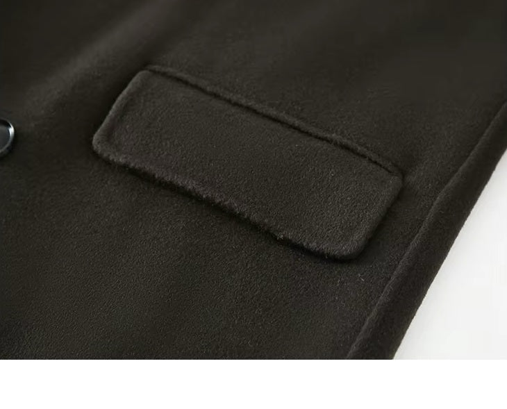 The flap pocket on the Men's Peaked-Lapel Wool Coat in Tuatara, highlighting precise stitching and structured design. From Borcelleclothes.