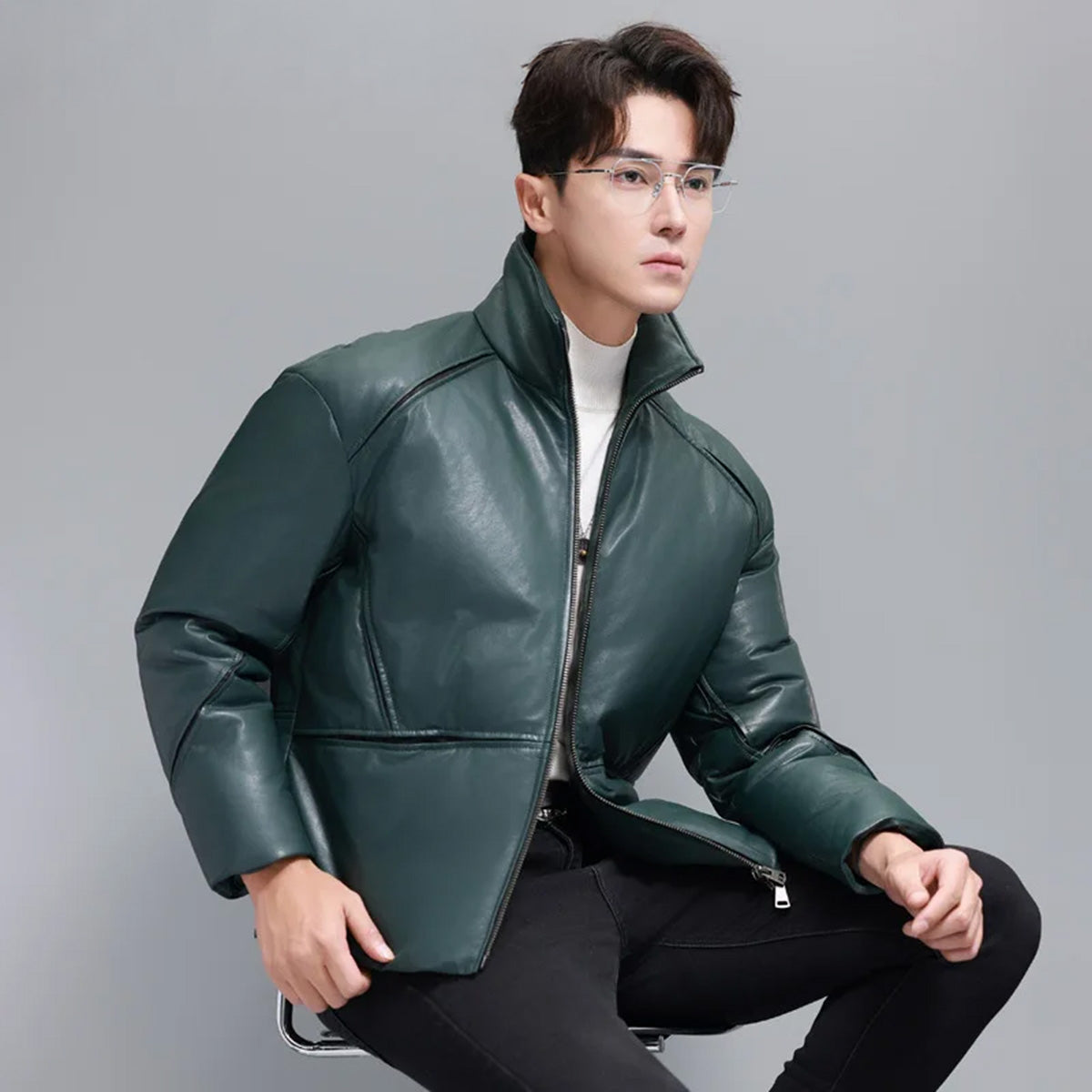 Model seated, wearing Winter Balsam sheepskin down jacket with visible curved yoke seams — From Borcelleclothes.